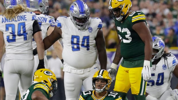 Packers QB Jordan Love sits on the ground after being sacked against the Lions