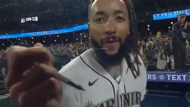Seattle Mariners SS J.P. Crawford signed a camera after walking off the Rangers on Thursday.