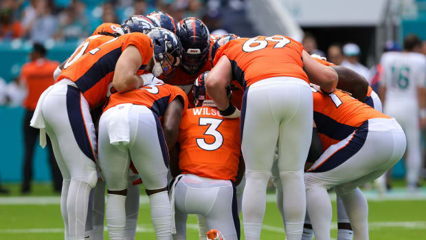 Denver Broncos quarterback Russell Wilson (3) leads a huddle against the Miami Dolphins in the first quarter at Hard Rock Stadium.