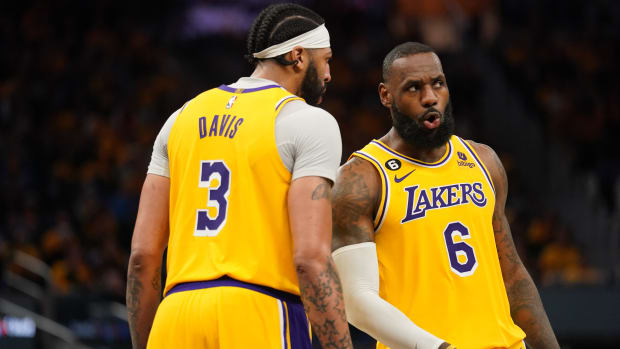 Los Angeles Lakers forward LeBron James talks with forward Anthony Davis.
