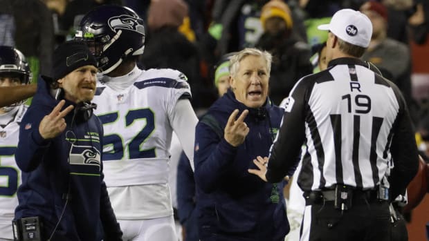 Nov 29, 2021; Landover, Maryland, USA; Seattle Seahawks special teams coordinator Larry Izzo (L) and Seahawks head coach Pete Carroll (M) argue with umpire Clay Martin (19) against the Washington Football Team at FedExField.
