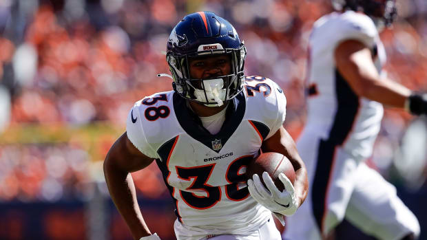 Denver Broncos running back Jaleel McLaughlin (38) runs for a touchdown in the first quarter against the Washington Commanders at Empower Field at Mile High.