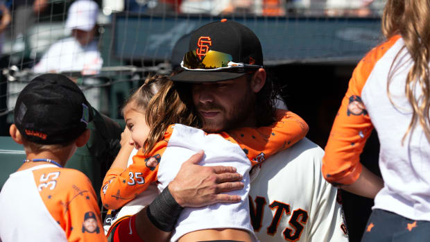 SF Giants shortstop Brandon Crawford hugs one of his children before his team takes on the Los Angeles Dodgers at Oracle Park on October 1, 2023.