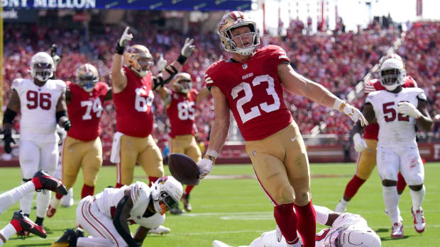 San Francisco 49ers running back Christian McCaffrey (23) reacts after scoring a touchdown in front of Arizona Cardinals safety Jalen Thompson (34) in the second quarter at Levi's Stadium.