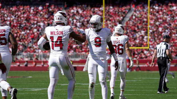 Arizona Cardinals wide receiver Michael Wilson (14) is congratulated by quarterback Joshua Dobbs (9) after catching a touchdown pass against the San Francisco 49ers in the second quarter at Levi's Stadium.
