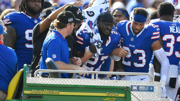 Buffalo Bills cornerback Tre'Davious White (27), center, is assisted onto the back of a cart after sustaining an injury during the second half an NFL football game against the Miami Dolphins, Sunday, Oct. 1, 2023, in Orchard Park, N.Y. (AP Photo/Adrian Kraus)   