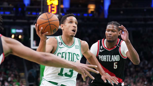 Boston Celtics guard Malcolm Brogdon (13) drives the ball against Portland Trail Blazers forward Cam Reddish (5) in the second half at TD Garden.