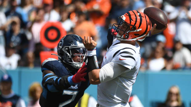 Bengals quarterback Joe Burrow (9) is hit by Tennessee Titans linebacker Azeez Al-Shaair (2) as he throws the ball during the first half at Nissan Stadium. 