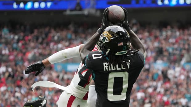 Jacksonville Jaguars wide receiver Calvin Ridley (0) catches a 39-yard touchdown pass against Atlanta Falcons cornerback A.J. Terrell (24) in the first half during an NFL International Series game at Wembley Stadium.