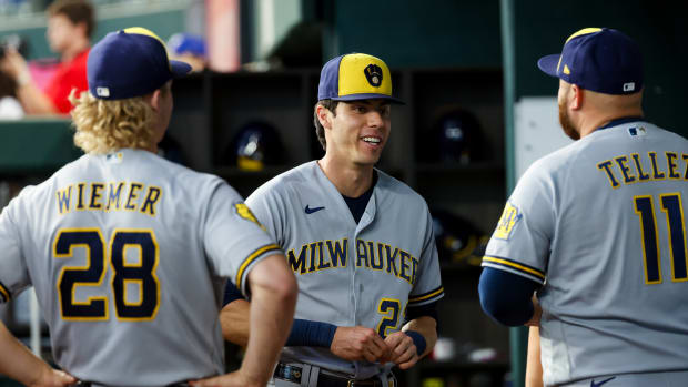 Aug 19, 2023; Arlington, Texas, USA; Milwaukee Brewers left fielder Christian Yelich (22) speaks with Milwaukee Brewers center fielder Joey Wiemer (28) and Milwaukee Brewers designated hitter Rowdy Tellez (11) before the game against the Texas Rangers at Globe Life Field.