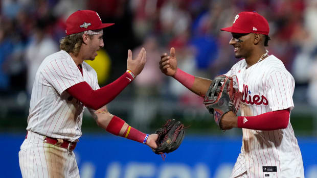 Phillies players Bryson Stott (left) and Johan Rojas celebrate after winning Game 1 of the 2023 NL wild-card series.