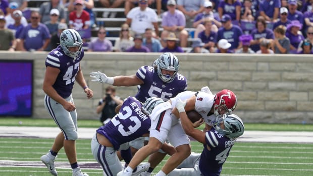 Sep 9, 2023; Manhattan, Kansas, USA; Troy Trojans quarterback Goose Crowder (9) is tackled by Kansas State Wildcats linebacker Austin Romaine (45), defensive tackle Damian Ilalio (56) and linebacker Asa Newsom (23) during the fourth quarter at Bill Snyder Family Football Stadium. Mandatory Credit: Scott Sewell-USA TODAY Sports