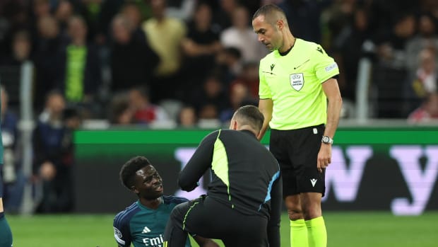 Bukayo Saka pictured receiving medical treatment before being substituted off during Arsenal's 2-1 defeat at Lens in the UEFA Champions League in October 2023