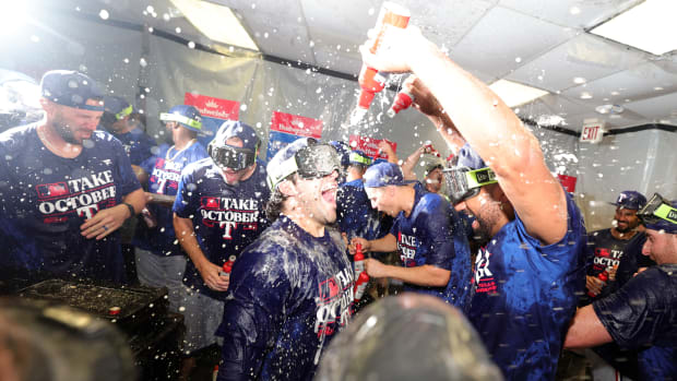 Texas Rangers shortstop Josh Smith (center) celebrates with teammates in the locker room after sweeping the Tampa Bay Rays in the Wild Card series Wednesday at Tropicana Field.
