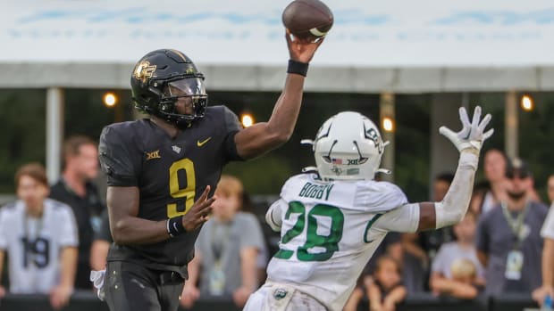 Sep 30, 2023; Orlando, Florida, USA; UCF Knights quarterback Timmy McClain (9) throws a pass in front of Baylor Bears safety Devyn Bobby (28) during the second half at FBC Mortgage Stadium.