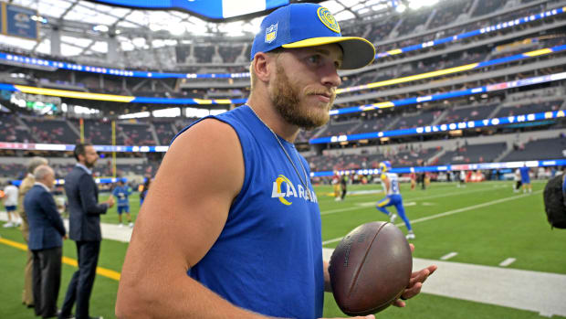 Rams receiver Cooper Kupp holds a football in his left hand.