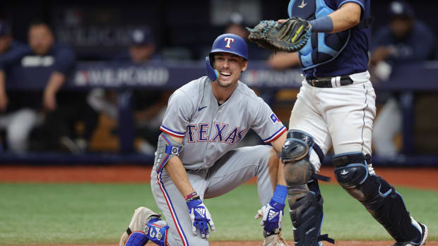Texas Rangers rookie Evan Carter reacts after being hit by a pitch in the eighth inning Wednesday during the Wild Card series win against the Tampa Bay Rays at Tropicana Field.