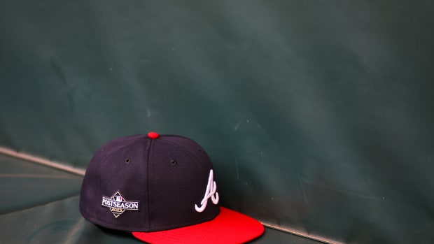 Oct 6, 2023; Atlanta, GA, USA; A detailed view of an Atlanta Braves postseason hat on the bench during a workout before the NLDS against the Philadelphia Phillies at Truist Park