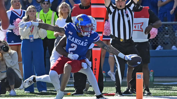 Oct 7, 2023; Lawrence, Kansas, USA; Kansas Jayhawks wide receiver Lawrence Arnold (2) stretches the ball over the goal line for a touchdown during the first half against the UCF Knights at David Booth Kansas Memorial Stadium. 
