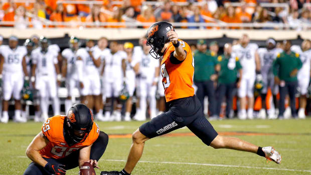 Tanner Brown (49) is in competition with Alex Hale for the starting placekicker job in Oklahoma State's preseason camp. cover main