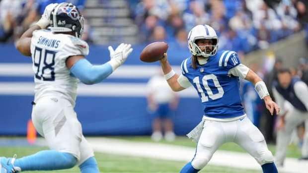 Oct 8, 2023; Indianapolis, Indiana, USA; Indianapolis Colts quarterback Gardner Minshew (10) draws back to pass as Tennessee Titans defensive tackle Jeffery Simmons (98) moves during a game against the Tennessee Titans at Lucas Oil Stadium.