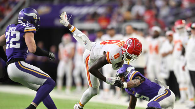 Oct 8, 2023; Minneapolis, Minnesota, USA; Kansas City Chiefs wide receiver Justyn Ross (8) gets yards after the catch as safety Harrison Smith (22) and cornerback Mekhi Blackmon (5) make the tackle during the third quarter at U.S. Bank Stadium. Mandatory Credit: Jeffrey Becker-USA TODAY Sports  