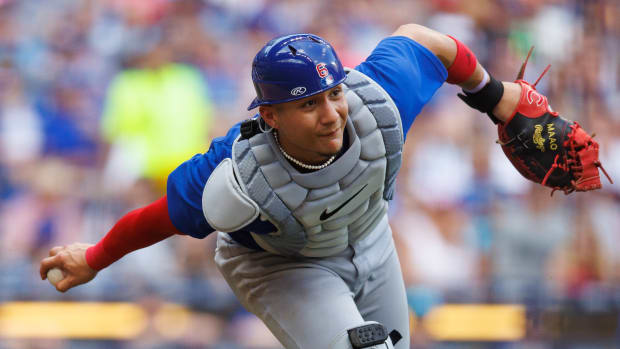 Jul 4, 2023; Milwaukee, Wisconsin, USA; Chicago Cubs catcher Miguel Amaya (6) underhands the ball towards first base during the sixth inning against the Milwaukee Brewers at American Family Field. Mandatory Credit: Jeff Hanisch-USA TODAY Sports
