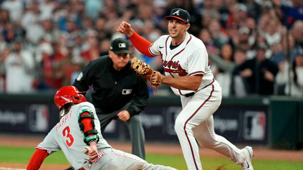 Oct 9, 2023; Cumberland, Georgia, USA; Atlanta Braves first baseman Matt Olson (28) forces out Philadelphia Phillies designated hitter Bryce Harper (3) for the final out of game two of the NLDS for the 2023 MLB playoffs at Truist Park. Mandatory Credit: Dale Zanine-USA TODAY Sports