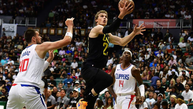Utah Jazz forward Lauri Markkanen (23) drives to the basket between Los Angeles Clippers center Ivica Zubac (40) and guard Terance Mann (14) during the first quarter at SimpliFi Arena at Stan Sheriff Center.