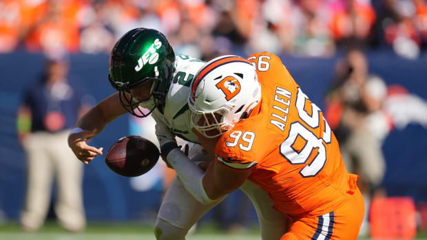 New York Jets quarterback Zach Wilson (2) fumbles after a sack by Denver Broncos defensive end Zach Allen (99) in the first quarter at Empower Field at Mile High.