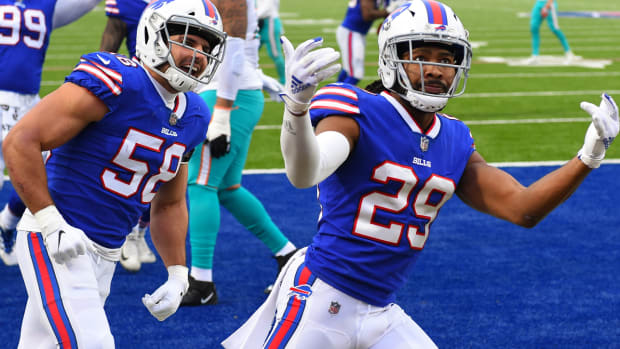 Jan 3, 2021; Orchard Park, New York, USA; Buffalo Bills cornerback Josh Norman (29) reacts to his interception return for a touchdown with teammate outside linebacker Matt Milano (58) against the Miami Dolphins during the third quarter at Bills Stadium. Mandatory Credit: Rich Barnes-USA TODAY Sports  