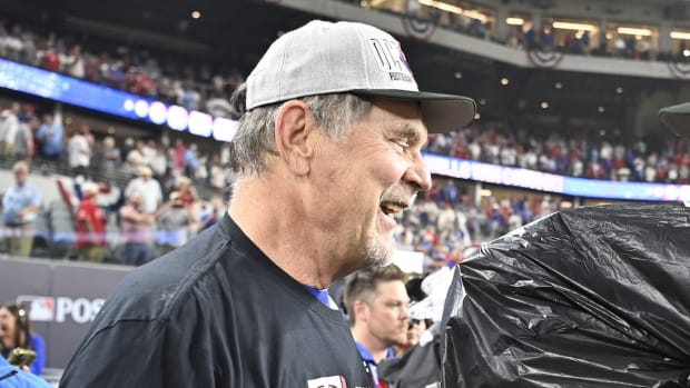 Oct 10, 2023; Arlington, Texas, USA; Texas Rangers owner Ray C. Davis talks with manager Bruce Bochy (15) on field after the win against the Baltimore Orioles in game three of the ALDS for the 2023 MLB playoffs at Globe Life Field. Mandatory Credit: Jerome Miron-USA TODAY Sports