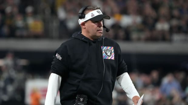 Josh McDaniels watches a Raiders game from the sideline