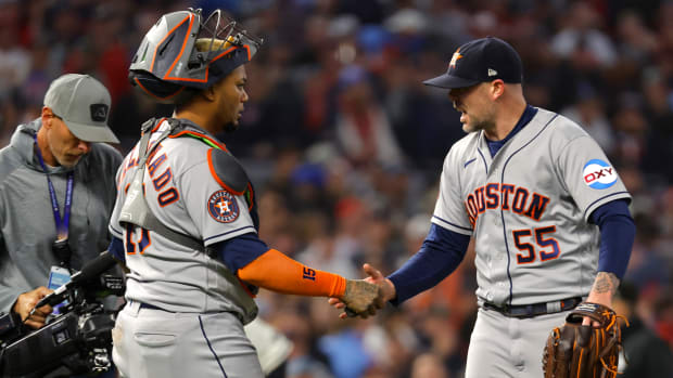 Astros relief pitcher Ryan Pressly (right) shakes hands with catcher Martín Maldonado after the ninth inning of Game 4 of the ALDS.