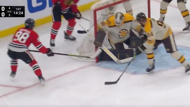 Blackhawks forward Connor Bedard scores his first NHL goal against the Bruins.