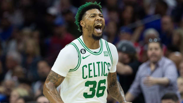 Former Celtics guard Marcus Smart yells after scoring during a game against the 76ers.