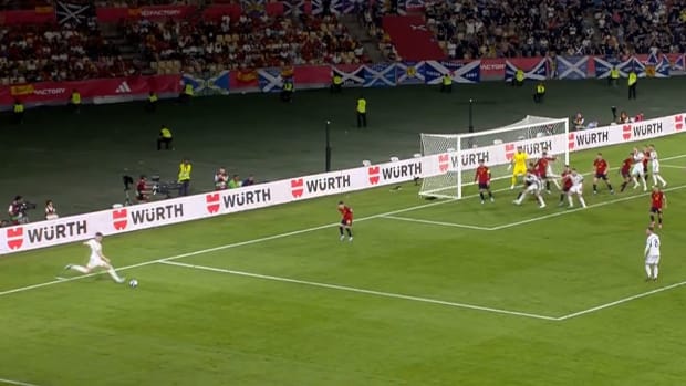Scott McTominay pictured (left) shooting from a free-kick during Scotland's Euro 2024 qualifier against Spain in October 2023