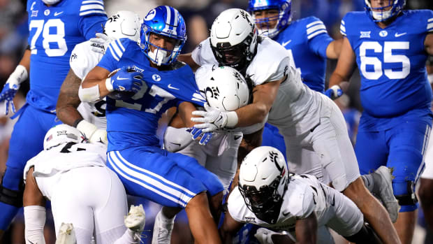 Brigham Young Cougars running back LJ Martin (27) is gang tackled by the Cincinnati Bearcats defense in the third quarter during a college football game between the Brigham Young Cougars and the Cincinnati Bearcats, Saturday, Sept. 30, 2023, at LaVell Edwards Stadium in Provo, Utah.