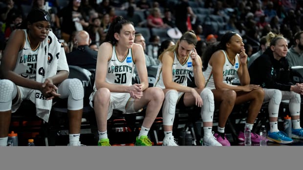 New York Liberty players Jonquel Jones, Breanna Stewart and Sabrina Ionescu sit on the bench as they trail the Las Vegas Aces in Game 2 of the WNBA Finals.
