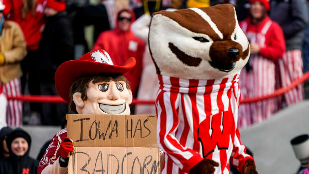 Nov 19, 2022; Lincoln, Nebraska, USA; Herbie Husker and Bucky Badger pose with a Iowa has bad corn sign during the game between the Nebraska Cornhuskers and the Wisconsin Badgers at Memorial Stadium. Mandatory Credit: Dylan Widger-USA TODAY Sports