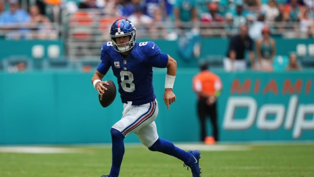 Oct 8, 2023; Miami Gardens, Florida, USA; New York Giants quarterback Daniel Jones (8) scrambles with the ball against the Miami Dolphins during the second half at Hard Rock Stadium.