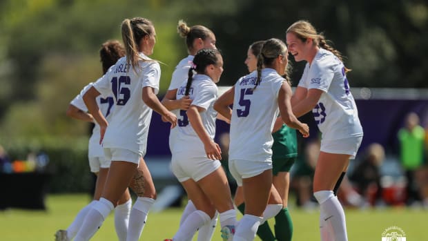 A.J. Hennessey (3) and the Frogs celebrate after her penalty in the 8th minute.
