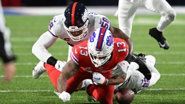 Oct 15, 2023; Orchard Park, New York, USA; Buffalo Bills wide receiver Gabe Davis (13) fumbles the ball on a tackle by New York Giants linebacker Bobby Okereke (58) in the first quarter at Highmark Stadium.