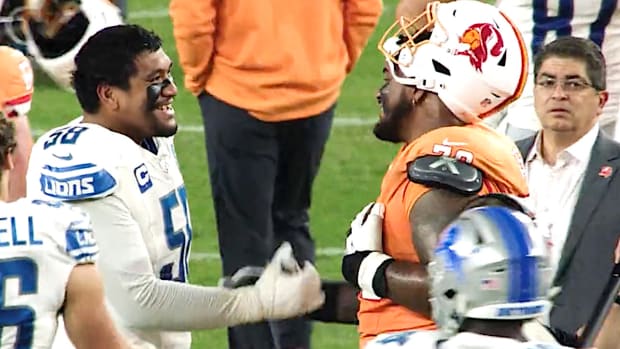 Penei Sewell of the Detroit Lions meets with the Tampa Bay Buccaneers' Tristan Wirfs after their game on Oct. 15, 2023.