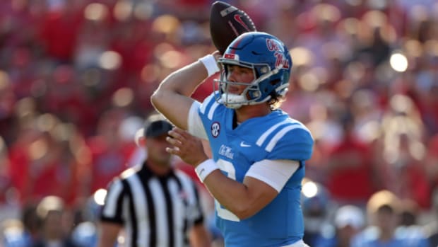 Ole Miss Rebels quarterback Jaxson Dart attempts a pass during a college football game in the SEC.