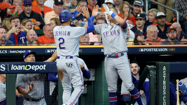 Oct 16, 2023; Houston, Texas, USA; Texas Rangers second baseman Marcus Semien (2) celebrates with third baseman Josh Jung (6) after scoring in the first inning against the Houston Astros during game two of the ALCS for the 2023 MLB playoffs at Minute Maid Park.