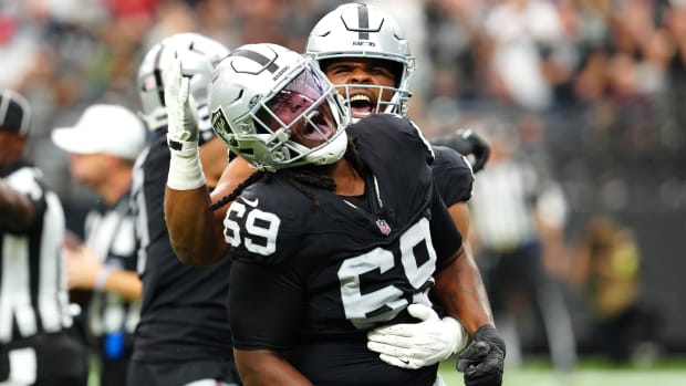 Oct 15, 2023; Paradise, Nevada, USA; Las Vegas Raiders defensive tackle Adam Butler (69) celebrates with Las Vegas Raiders defensive tackle Jerry Tillery (90) after making a play against the New England Patriots during the first quarter at Allegiant Stadium.