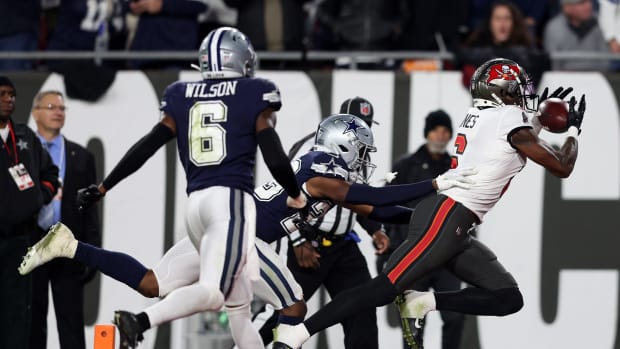 Jan 16, 2023; Tampa, Florida, USA; Tampa Bay Buccaneers wide receiver Julio Jones (6) makes a touchdown catch over Dallas Cowboys safety Donovan Wilson (6) in the second half during the wild card game at Raymond James Stadium.