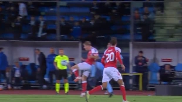 Rasmus Hojlund pictured being kneed in the back during Denmark's 2-1 win over San Marino in October 2023