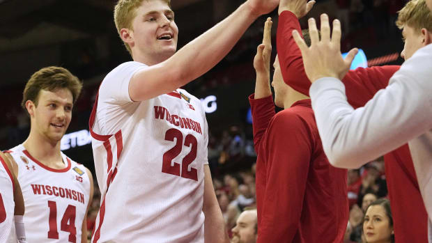 March 14, 2023; Madison, Wisconsin, USA; Wisconsin Badgers forward Steven Crowl (22) is congratulated by teammates during the second half of their opening round game of the National Invitation Tournament against the Bradley Braves at the Kohl Center. Wisconsin beat Bradley 81-62. Mandatory Credit: Mark Hoffman - USA Today Sports